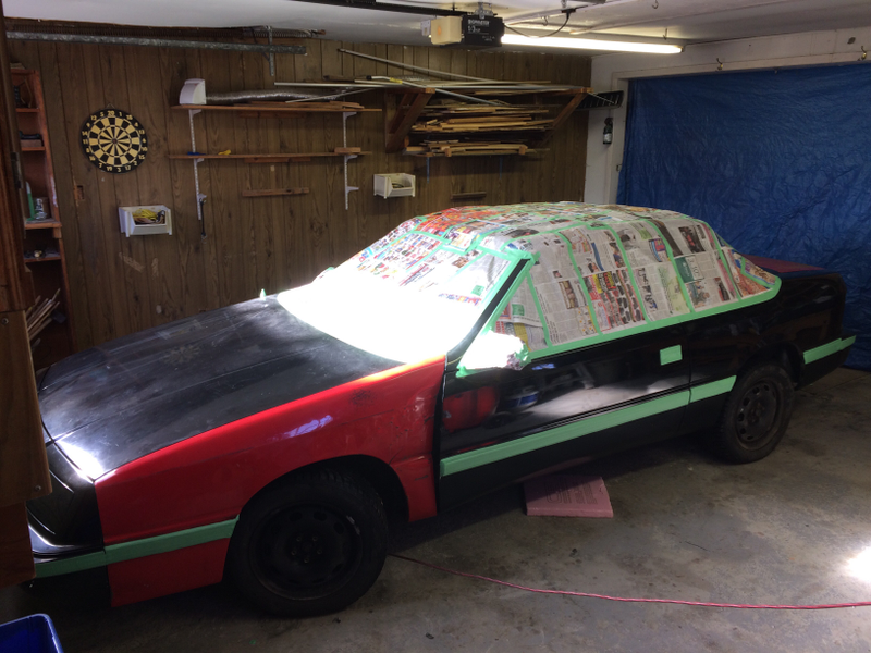 Painting the car, complete with the crunched fender from the red car installed.